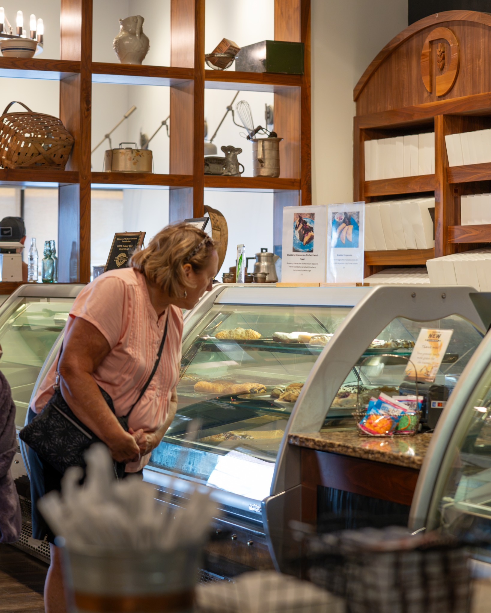 Guest browsing the bakery case at The Pioneer Bakery Cafe